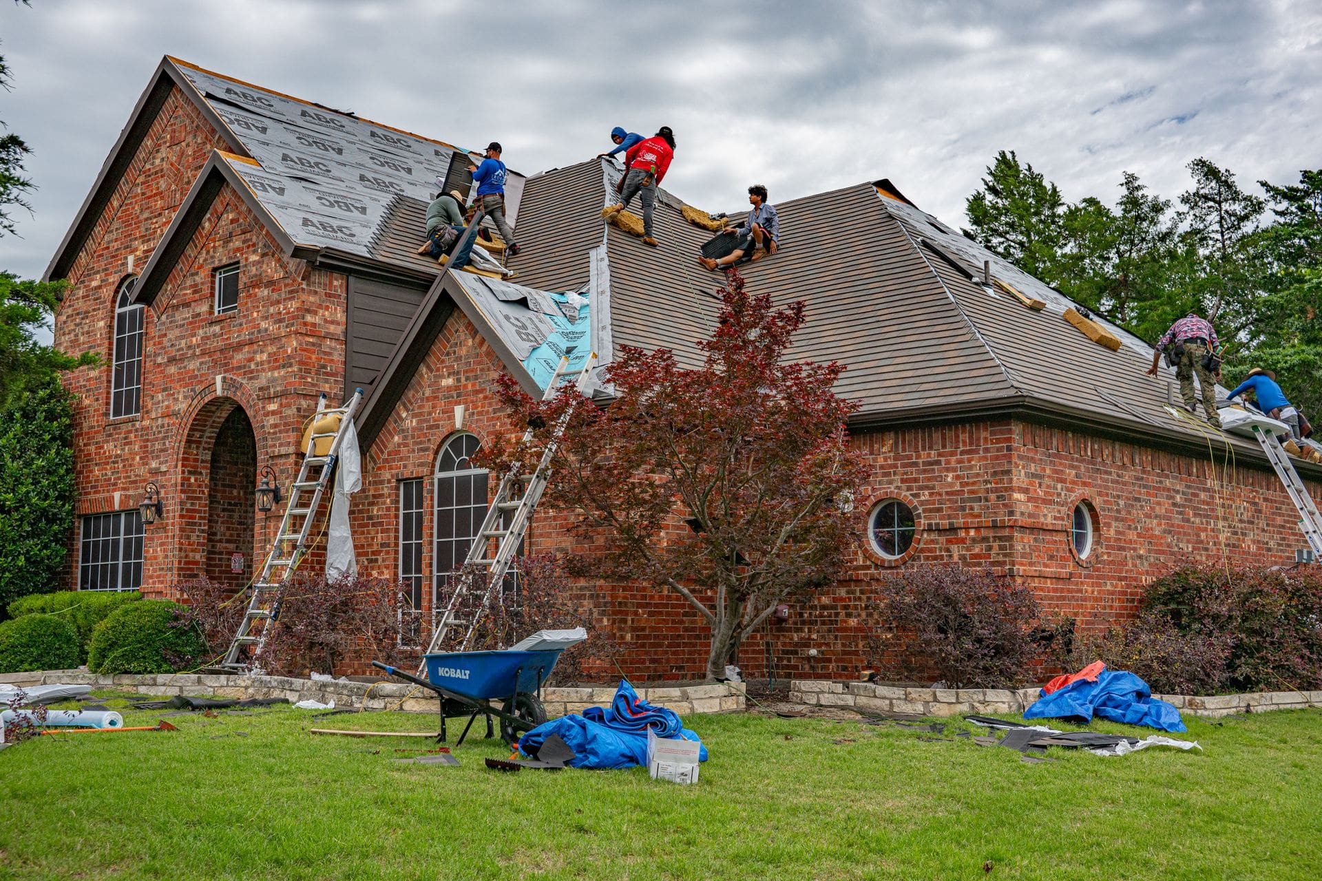 Roofing crew replacing a residential roof — roof repair and replacement by Carolina Roofing & Steel